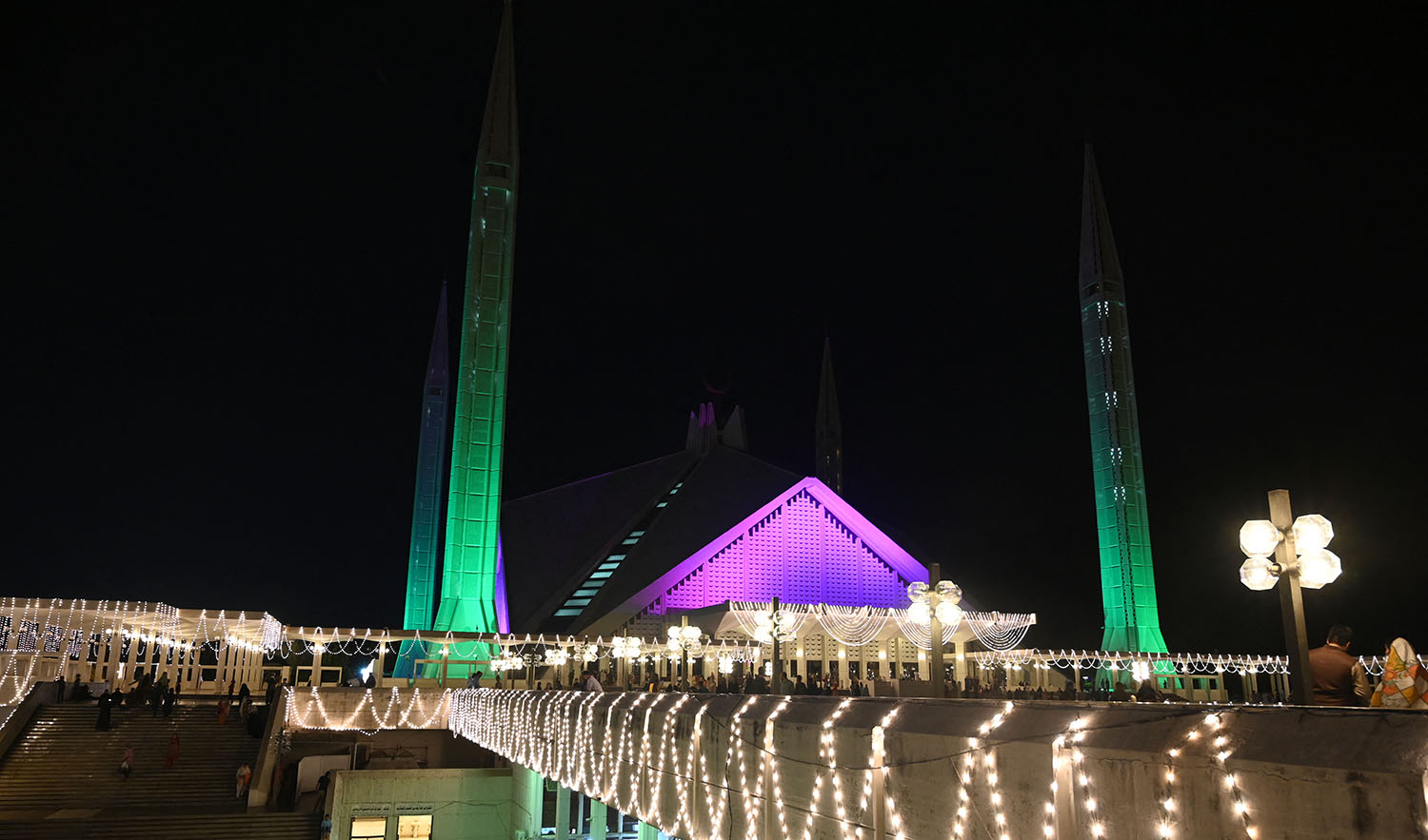 A photograph shows the illuminated Faisal mosque building during celebrations marking the Eid-e-Milad-un-Nabi, the birth of Prophet Muhammad (PBUH), in Islamabad, Pakistan on October 18, 2021. (AFP/File)