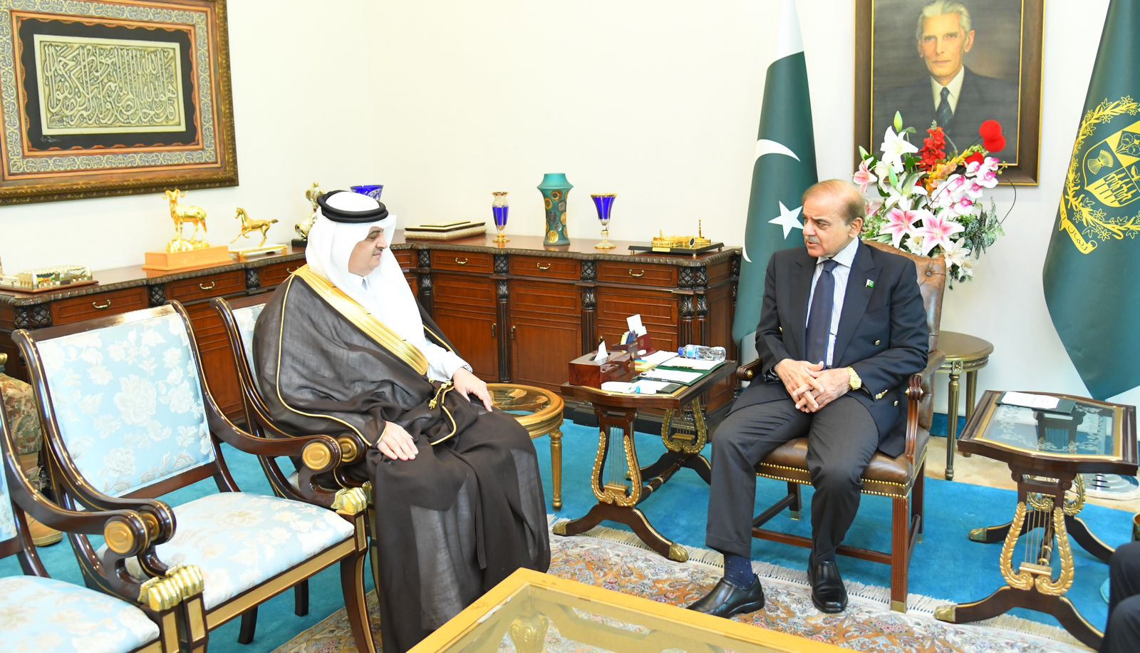 Pakistan's Prime Minister Shehbaz Sharif (R) speaks to Saudi Ambassador to Pakistan, Nawaf bin Said Al-Malki in Islamabad on September 27, 2022. (Prime Minister Office)