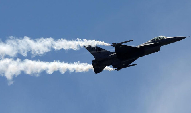 In this file photo, Pakistan Air Force (PAF) Sherdil squad's fighter jet F-16 is seen exhibiting skills in Karachi on March 23, 2017. (Reuters)
