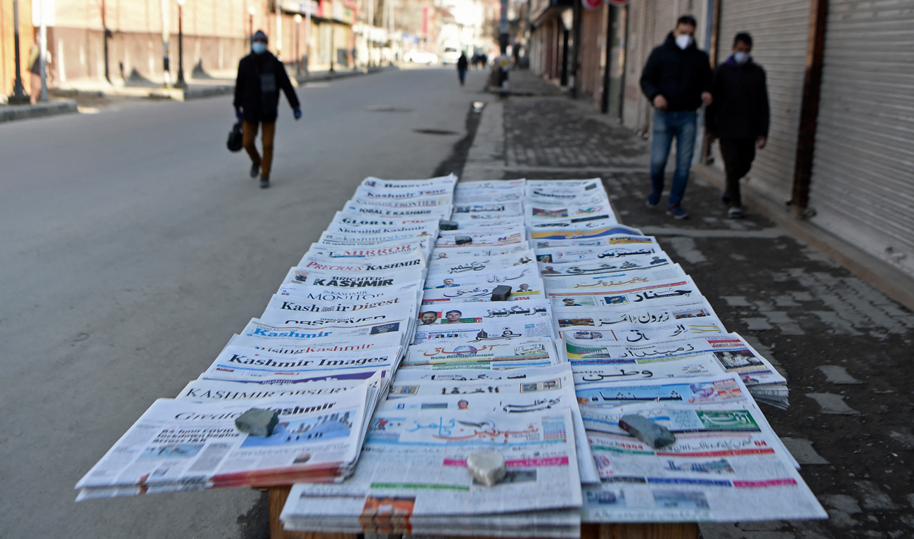 In this photo taken on January 29, 2022, local newspapers are placed on a newsstand along a road in Srinagar. (AFP/File)