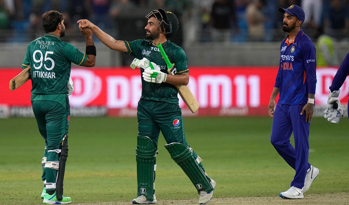 India's KL Rahul, right, watches as Pakistan's Iftikhar Ahmed, left, celebrates with batting partner Khushdil Shah after their win in the T20 cricket match of Asia Cup against India, in Dubai, United Arab Emirates, on September 4, 2022. (AP)