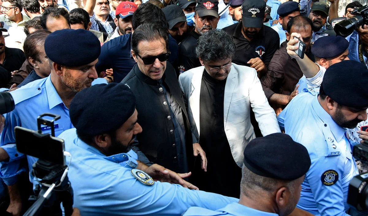 Former Pakistani Prime Minister Imran Khan, center, arrives to the Islamabad High Court surrounded by journalists and security in Islamabad, Pakistan, on September 8, 2022. (AP)