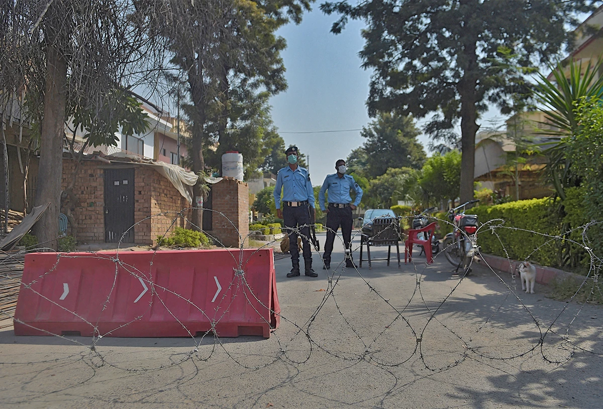 Pakistani policemen stand guard in front of a cordoned off area in Islamabad, Pakistan, on October 11, 2022. (AFP/File)
