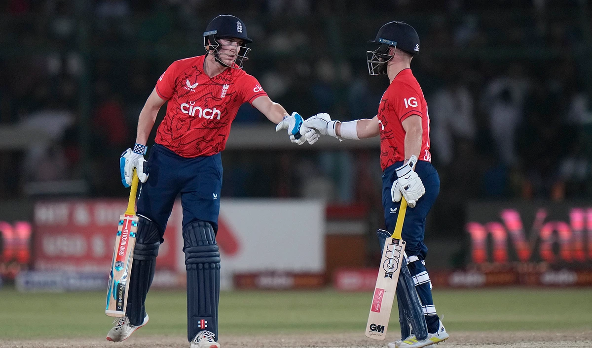 England's Harry Brook, left, celebrates with batting partner Ben Duckett after hitting a boundary during the third twenty20 cricket match between Pakistan and England, in Karachi, Pakistan, on September 23, 2022. (AP)