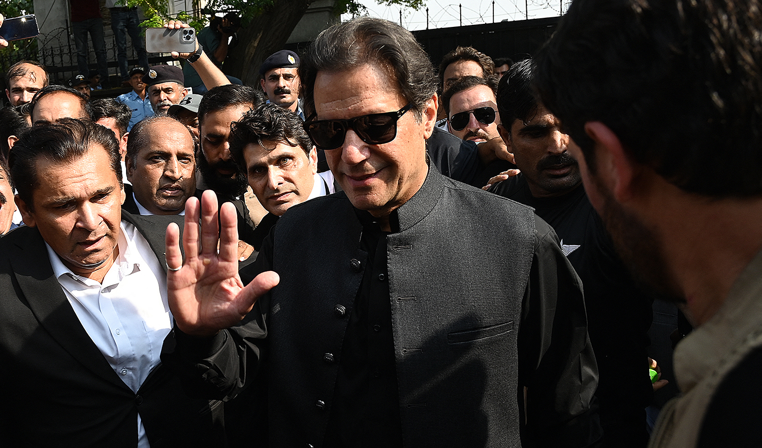 Pakistan's former Prime Minister Imran Khan (C) gestures as he leaves after appearing before the High Court in Islamabad on September 22, 2022. (AFP)
