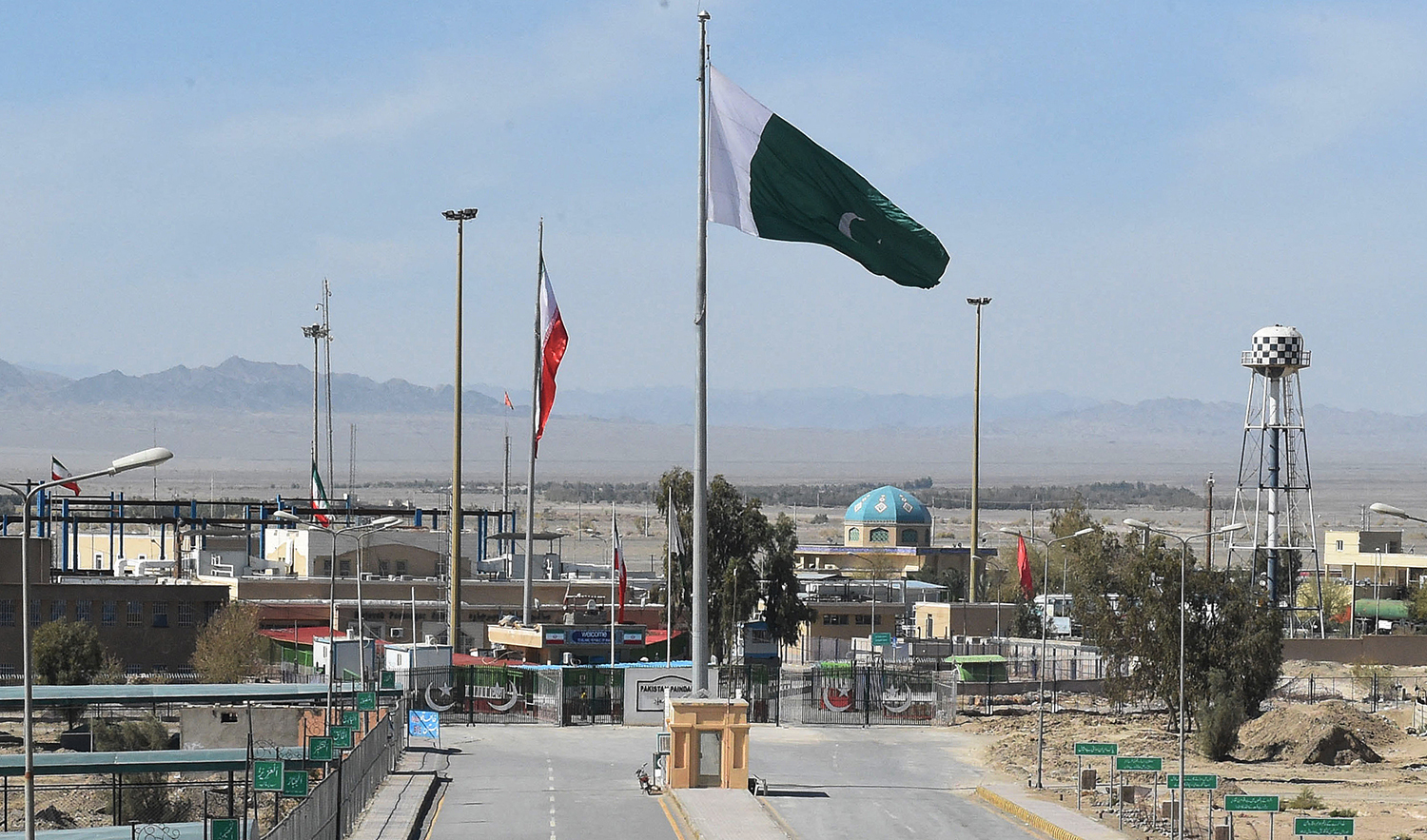 Pakistani and Iranian flags flutter on the closed Pakistan-Iran border in Taftan on February 25, 2020. (AFP/File)