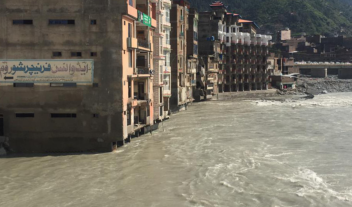 In this undated photo, flood waters inundated most riverside buildings when floods hit Swat valley. (Photo courtesy: Zahid Khan, president of the All Swat Hotel Association)