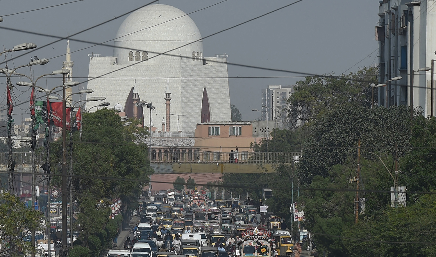 In this photograph taken on February 13, 2017, commuters drive on a busy street in the Pakistan's port city of Karachi. (AFP/File)