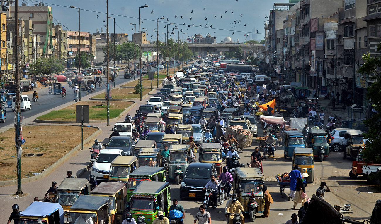 Commuters make their way along a busy road in Karachi, Pakistan, on May 11, 2020. (AFP)