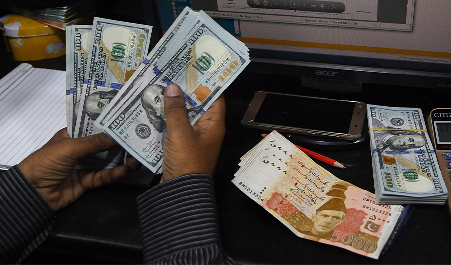 In this picture taken on April 15, 2019, a Pakistani dealer counts US dollars at a currency exchange shop in Karachi. (AFP)