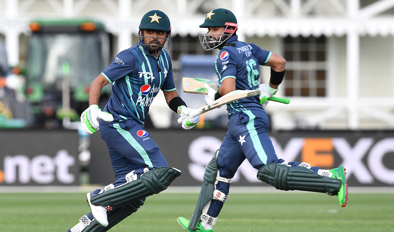 Pakistan's Babar Azam (L) and Mohammad Rizwan run between the wickets during the Twenty20 tri-series cricket match between Pakistan and Bangladesh at Hagley Oval in Christchurch on October 13, 2022. (AFP)