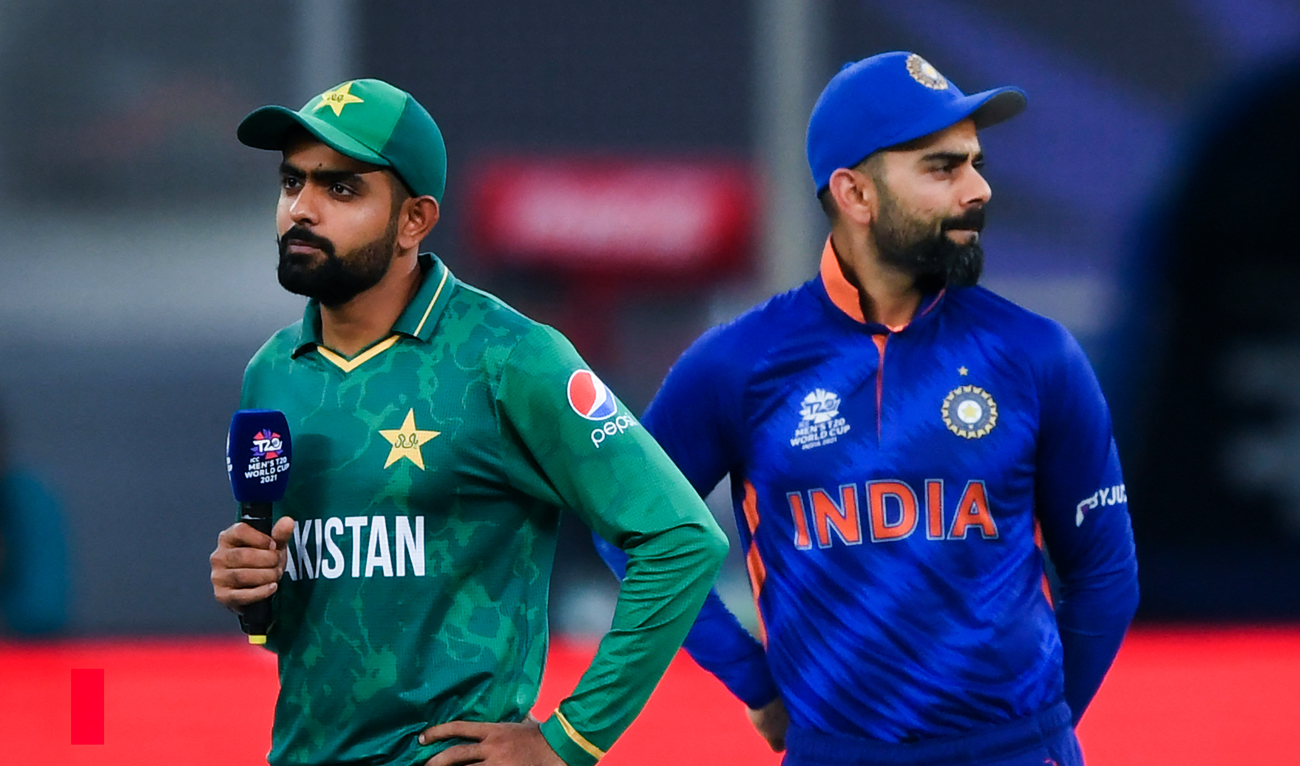India's captain Virat Kohli (R) and his Pakistan's counterpart Babar Azam arrive on the field for the toss before the start of the ICC men’s Twenty20 World Cup cricket match between India and Pakistan in Dubai on October 24, 2021. (AFP/File)