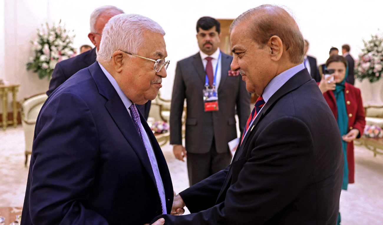 A handout picture provided by the Palestinian Authority's press office (PPO), shows Prime Minister of the Islamic Republic of Pakistan Muhammad Shehbaz (R) greeting Palestinian President Mahmoud Abbas, during the Conference on Interaction and Confidence-Building Measures in Asia (CICA) in Astana, Kazakhstan, on October 13 2022. (REUTERS via PPO)