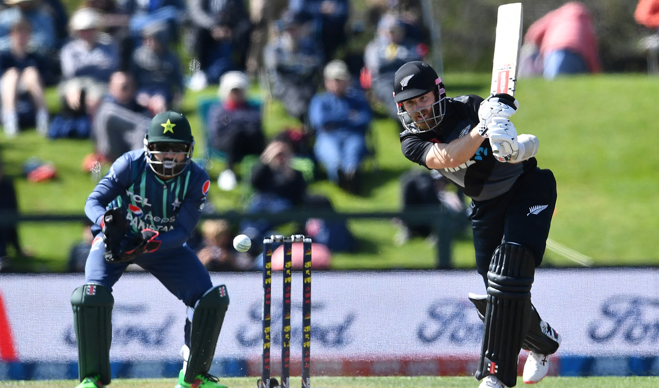 New Zealand's Kane Williamson plays a shot in front of Pakistan's wicketkeeper Mohammad Rizwan during the Twenty20 tri-series final cricket match between New Zealand and Pakistan at Hagley Oval in Christchurch on October 14, 2022. (AFP)