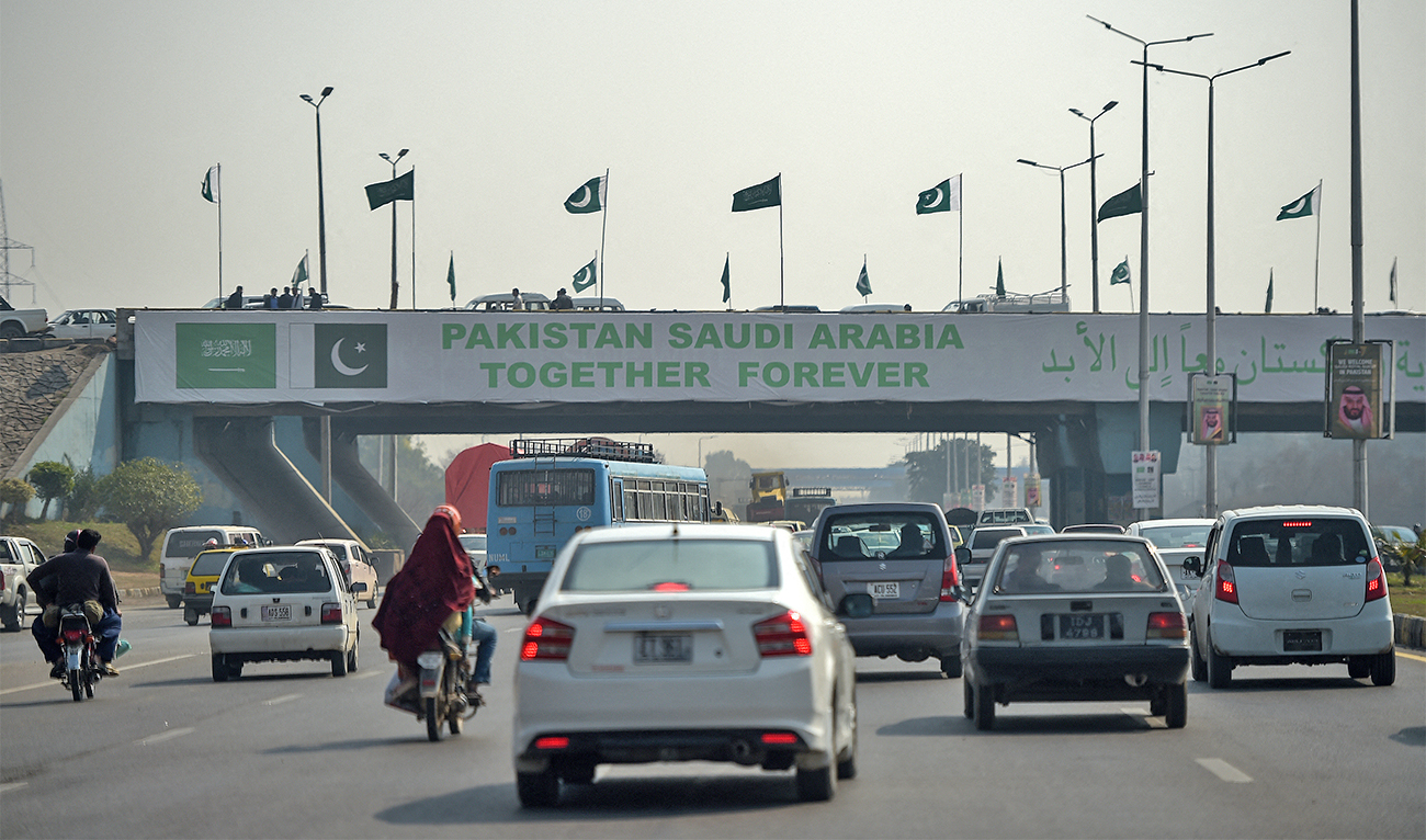 Pakistani commuters drive their vehicles under a banner welcoming Saudi Arabian Crown Prince Mohammed bin Salman displayed on a bridge, ahead of his arrival, in Islamabad on February 15, 2019. (AFP/File)