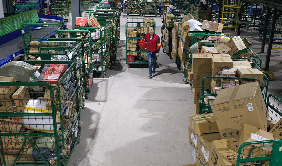 A worker transfers packages at a delivery company in Hengyang in China's central Hunan province early on November 12, 2019. (AFP/FILE)