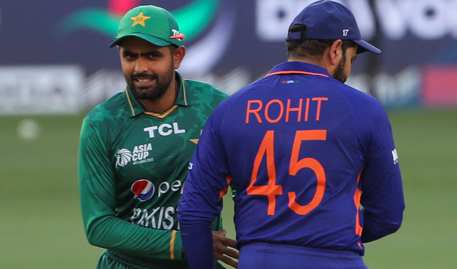 Pakistan's captain Babar Azam (L) walks past India's captain Rohit Sharma during the toss before the start of the Asia Cup Twenty20 international cricket Super Four match between India and Pakistan at the Dubai International Cricket Stadium in Dubai on September 4, 2022. (AFP)
