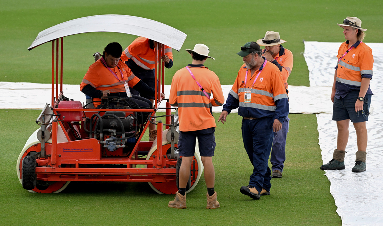Ground staff clear the wicket area as rain cancels training ahead of the second one-day international (ODI) cricket match between Australia and Zimbabwe at Riverway Stadium, in Townsville on August 30, 2022. (AFP/File)
