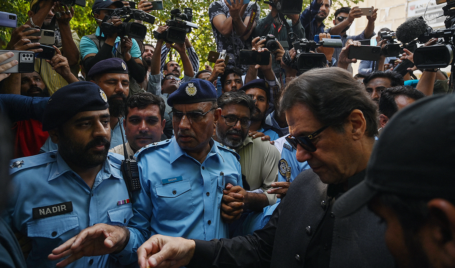 Pakistan's former Prime Minister Imran Khan (R) arrives to appear before the High Court in Islamabad on September 22, 2022. (AFP/File)