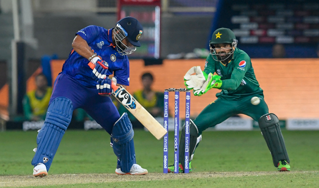 India's Rishabh Pant (L) plays a shot during the ICC men’s Twenty20 World Cup cricket match between India and Pakistan at the Dubai International Cricket Stadium in Dubai on October 24, 2021. (AFP/File)
