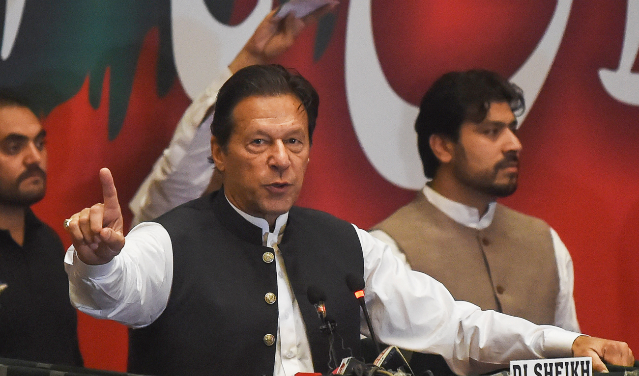 Former Pakistan's prime minister Imran Khan, who was ousted by opposition parties through a no-confidence motion, gestures as he addresses Pakistan Tehreek-e-Insaf (PTI) party workers during a party convention in Lahore on April 27, 2022. (AFP)