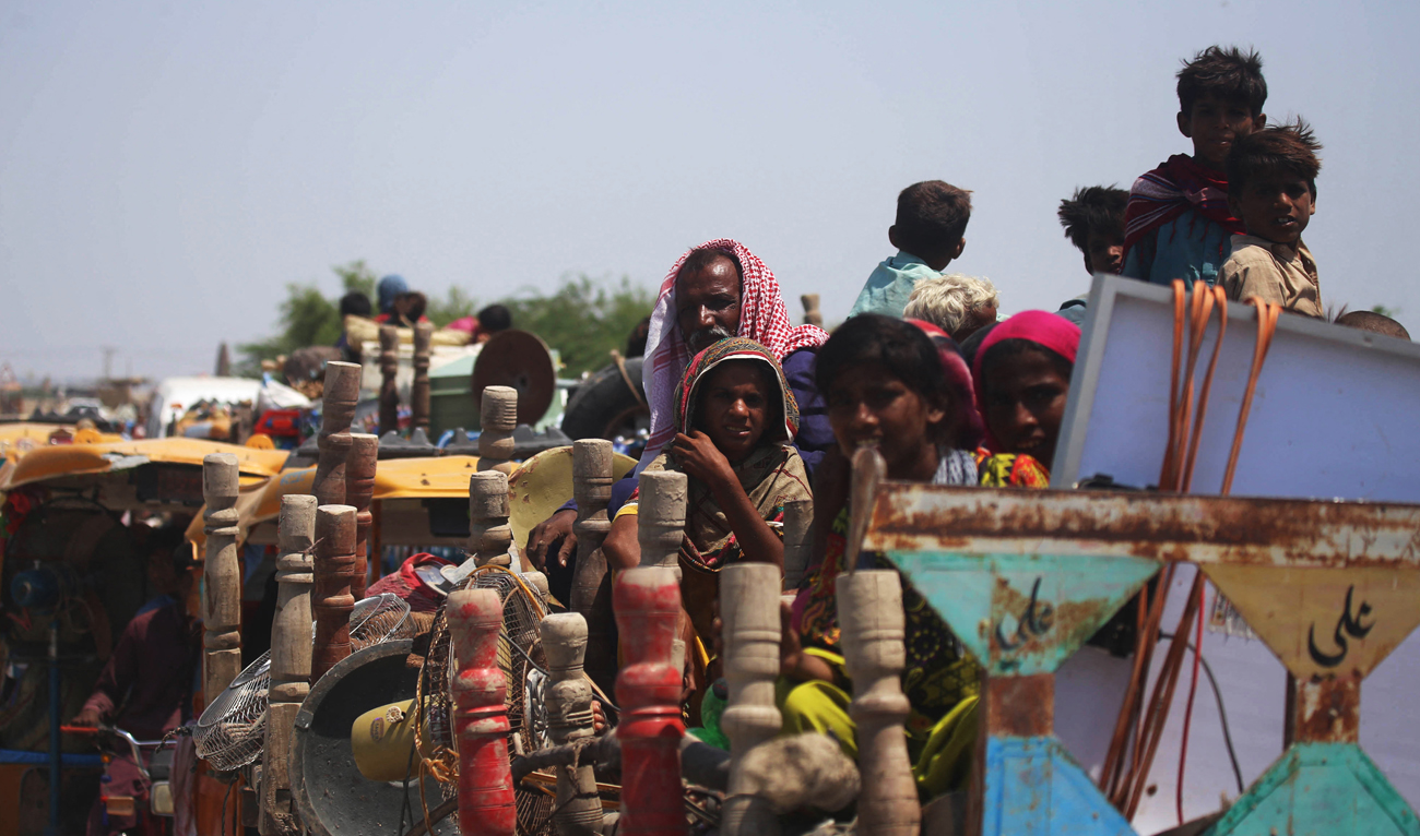 In this file photo, taken on September 8, 2022, internally displaced flood-affected residents along with their belongings arrive from the flooded areas to safer grounds after heavy monsoon rains in Sehwan of Jamshoro district, Sindh province. (AFP/File)