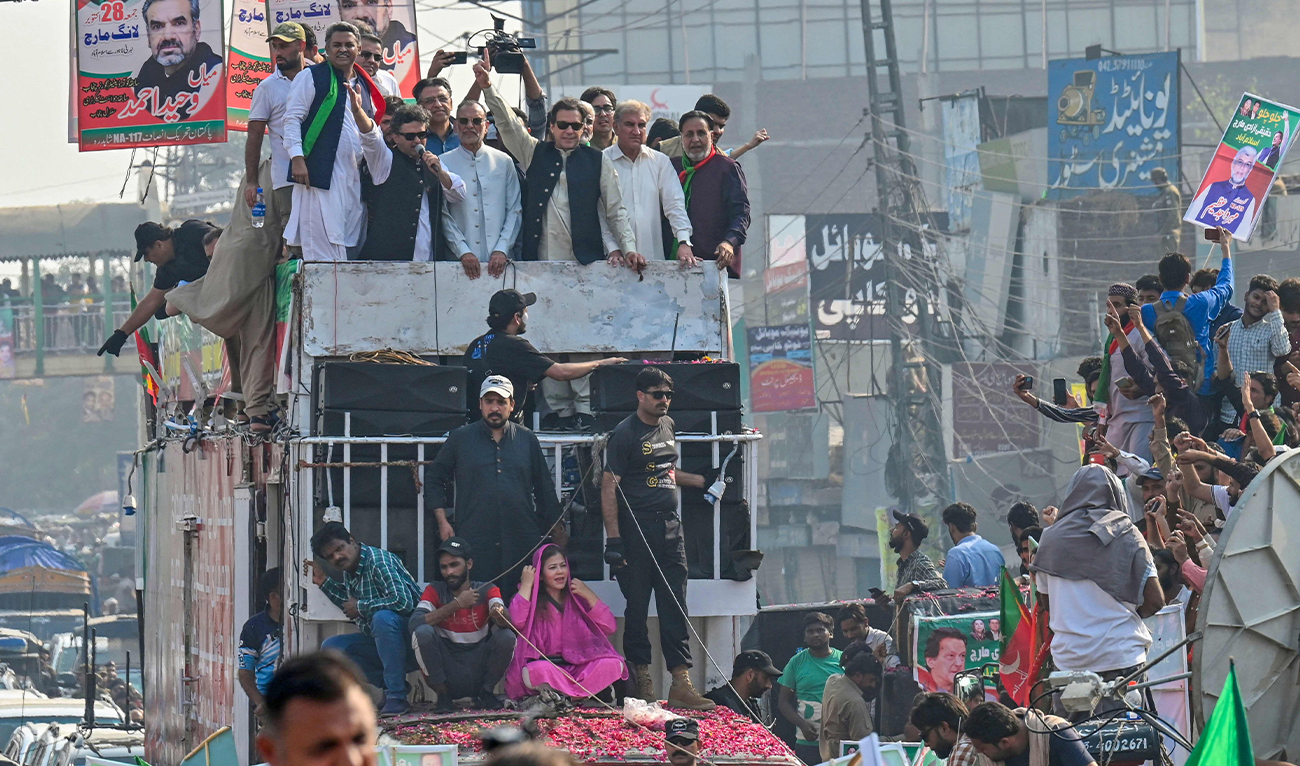 Former Pakistan prime minister Imran Khan (C) addresses his supporters during an anti-government long march towards Islamabad to demand early elections, in Lahore on October 29, 2022. (AFP)