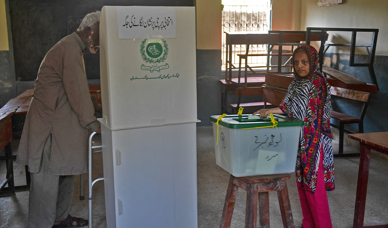 Voters cast their ballot at a polling station during the by-election for national assembly seats, in Karachi on October 16, 2022. (AFP/File)