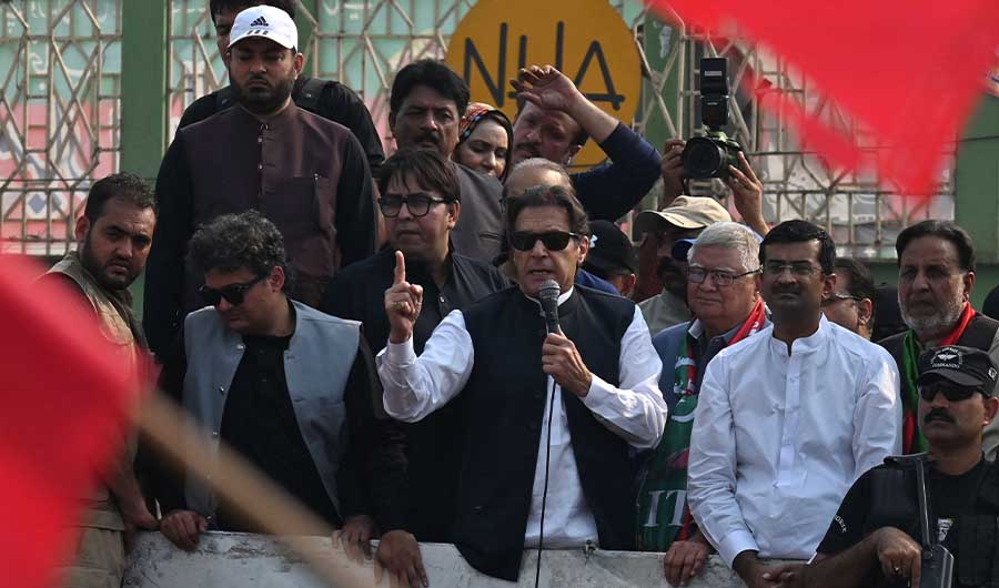 Pakistan's former prime minister Imran Khan (C) addresses his supporters during an anti-government march towards Islamabad city, demanding early elections, in Muridke district, about 29 km from Lahore on October 30, 2022. (AFP)