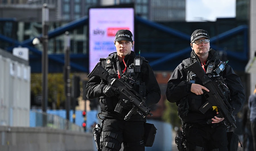 Armed police patrol outside the venue on the opening day of the annual Conservative Party Conference in Birmingham, central England, on October 2, 2022. (AFP)