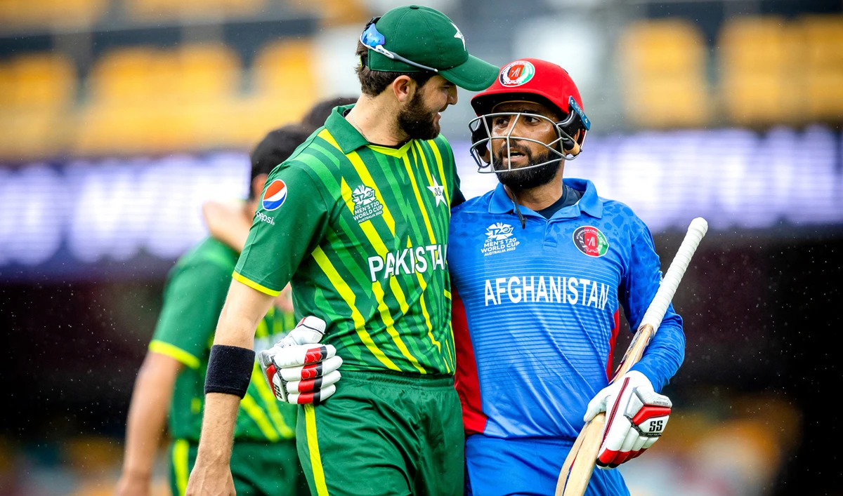 Pakistan's Shaheen Shah Afridi (L) embraces Usman Ghani (R) as they both walk off together during the ICC men's Twenty20 World Cup 2022 cricket warm-up match between Afghanistan and Pakistan at the Gabba in Brisbane on October 19, 2022. (AFP)
