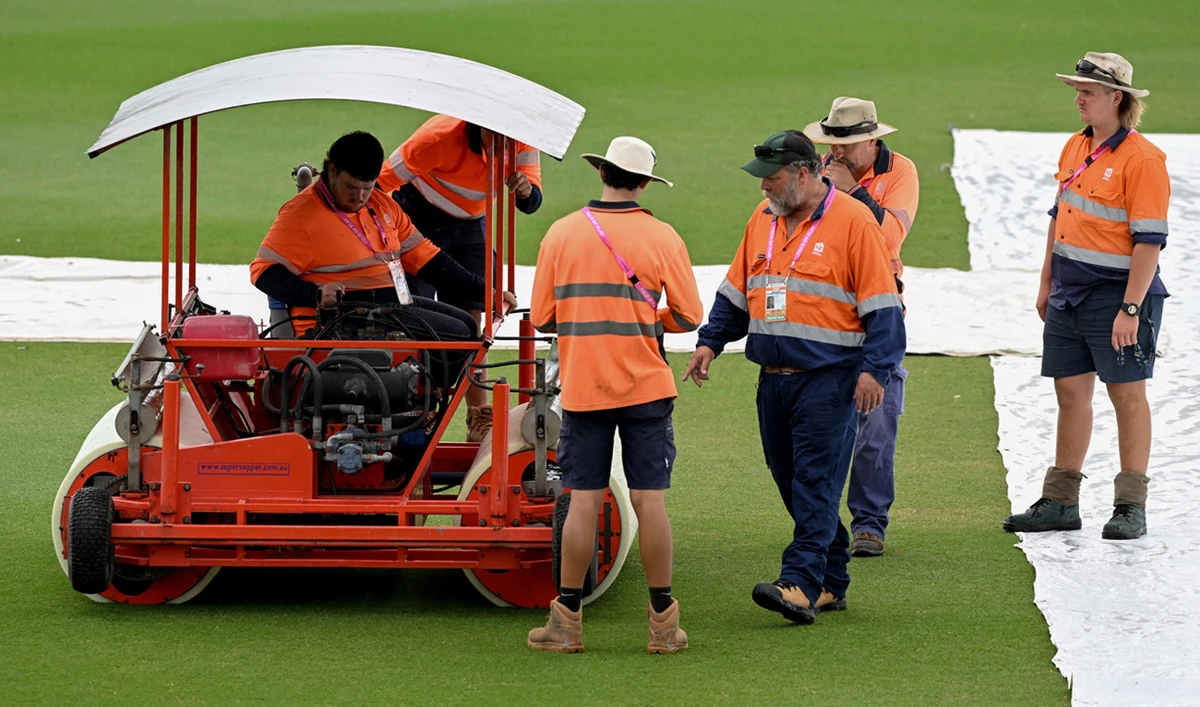Ground staff clear the wicket area as rain cancels training ahead of the second one-day international (ODI) cricket match between Australia and Zimbabwe at Riverway Stadium, in Townsville on August 30, 2022. (AFP/File)