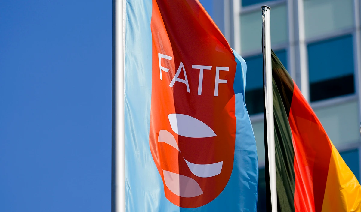 A flag with the logo of the Financial Action Task Force, FATF, waves in the wind next to the German national flag during a meeting of the task force at the Congress Center in Berlin, Germany, on June 17, 2022. (AP)