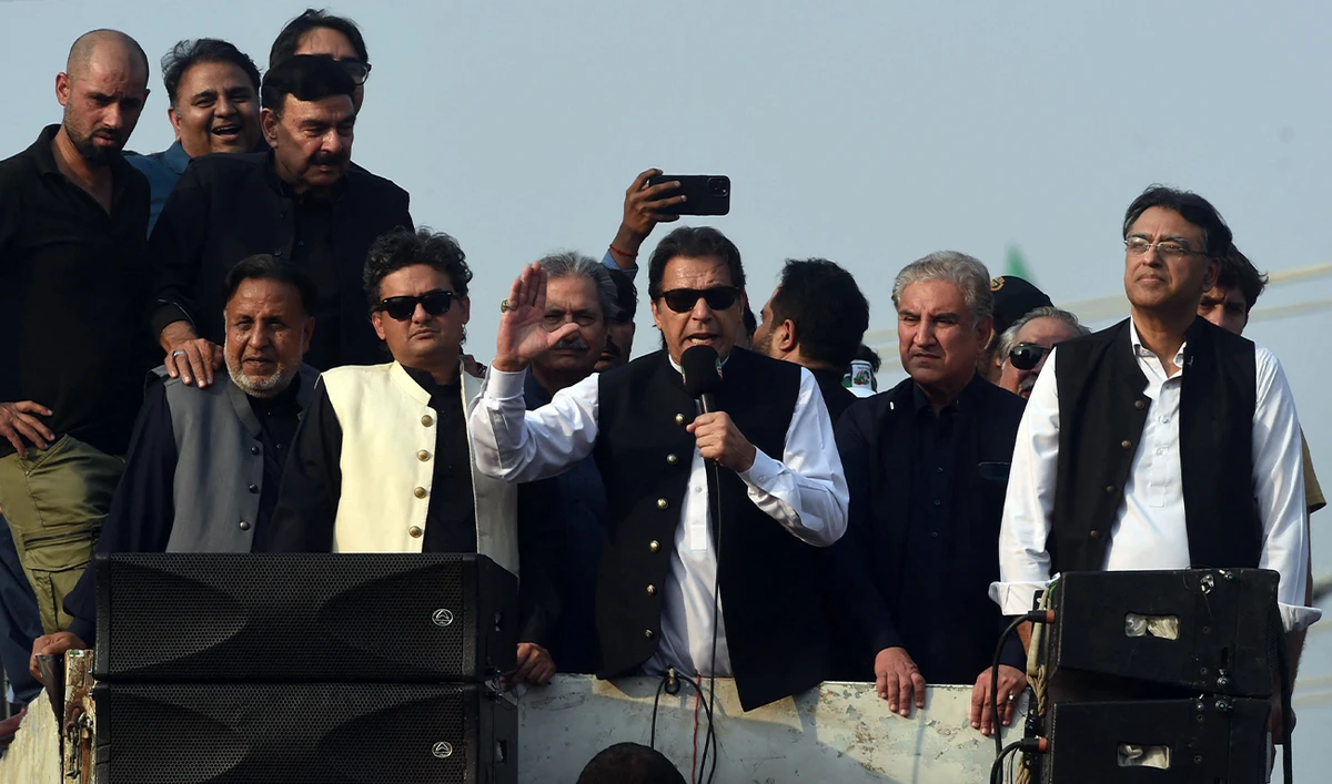 Former Pakistan prime minister Imran Khan (C) addresses his supporters during an anti-government long march towards Islamabad to demand early elections, in Lahore on October 28, 2022. (AFP)