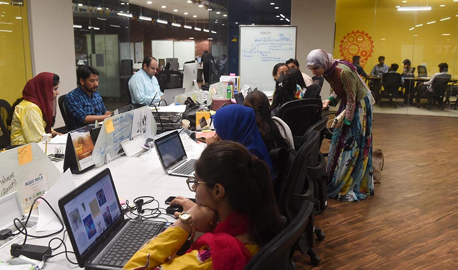 In this photograph taken on May 24, 2019, people work at their desks at the National Incubation Centre (NIC), a start-up incubator, in Lahore. (AFP/FILE)