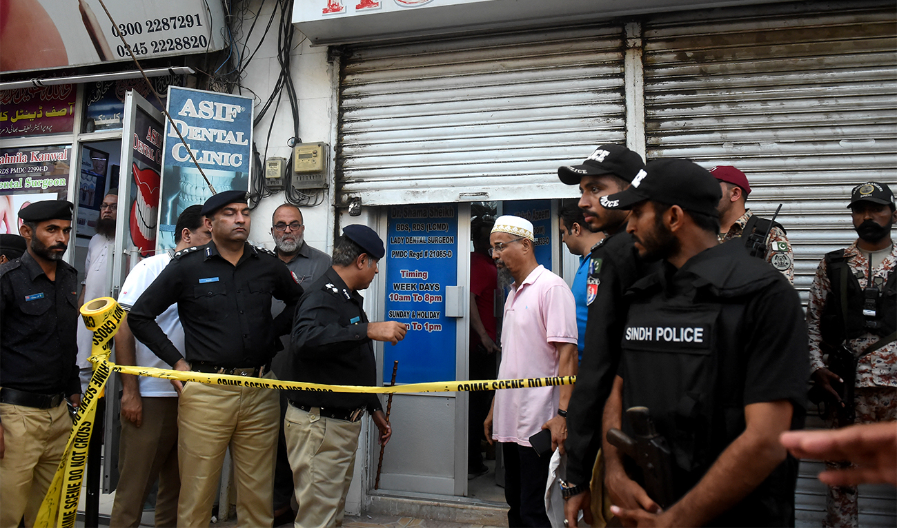 Policemen gather outside a dental clinic after a Chinese origin man was shot dead in an attack in Karachi, Pakistan, on September 28, 2022. (AFP/File)