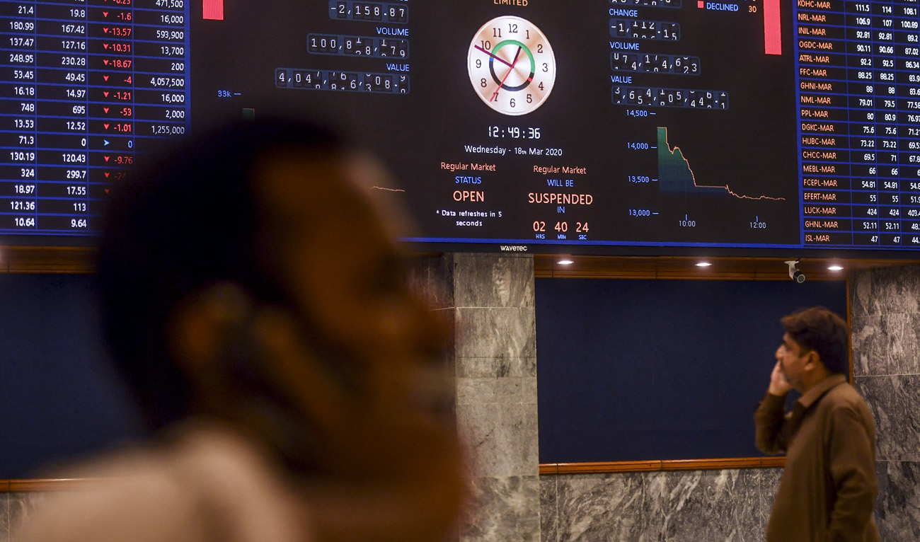 In this file photo, taken on March 18, 2020, stockbrokers watch the latest share prices during a trading session at the Pakistan Stock Exchange (PSX) in Karachi. (Photo courtesy: AFP/File)