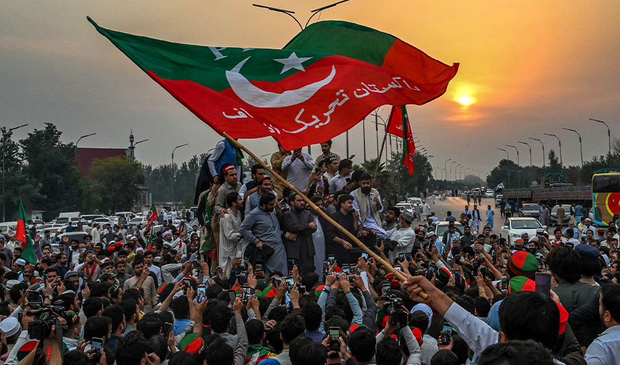 Supporters of former Pakistani prime minister Imran Khan, take part in a protest as they block the main road a day after the assassination attempt on Khan,in Peshawar on November 4, 2022. (AFP)