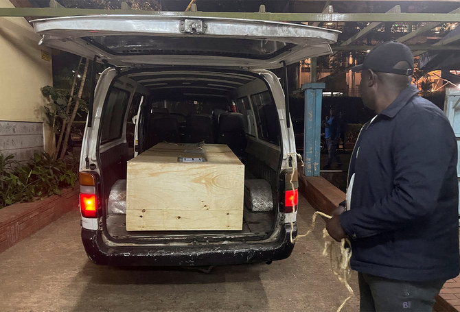 The wooden coffin containing the body of Pakistani journalist Arshad Sharif, who was shot dead when police hunting car thieves opened fire on the vehicle he was traveling in as it drove through their roadblock without stopping, is loaded into a courtesy van at the Chiromo mortuary in Nairobi, Kenya, on October 24, 2022. (REUTERS)