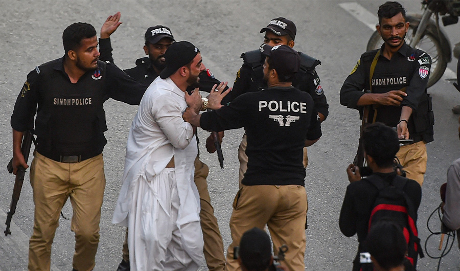 Police detains a supporter of former Pakistani prime minister Imran Khan, during a protest a day after the assassination attempt on Khan, in Karachi on November 4, 2022. (AFP)