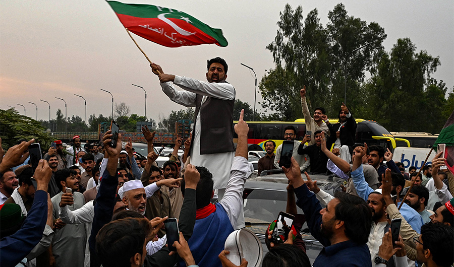 Supporters of former Pakistani prime minister Imran Khan, take part in a protest as they block the main road a day after the assassination attempt on Khan,in Peshawar on November 4, 2022. (AFP)