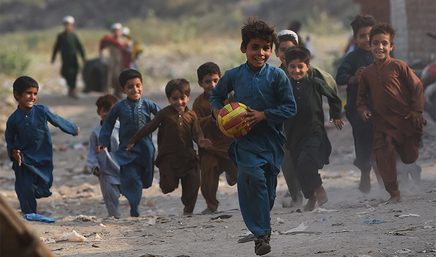 Children of Afghan refugees play in Afghan Basti area on the outskirts of Lahore on June 19, 2021 on the eve of World Refugee Day. (AFP/FILE)