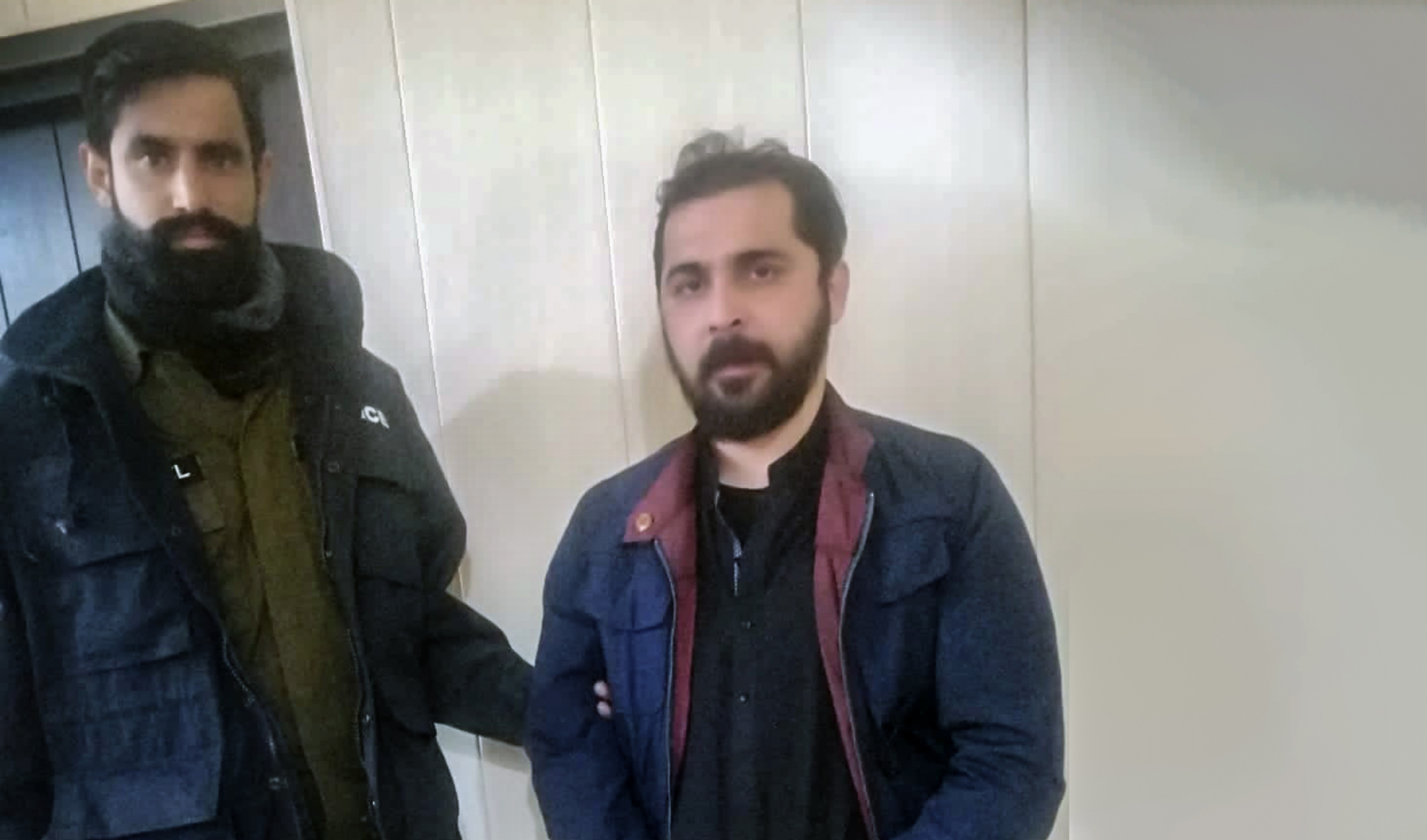 This undated file photo shows ex-husband of Pakistani-American national Wajiha Swati, right, in the custody of Rawalpindi police. (Photo courtesy:s social media)