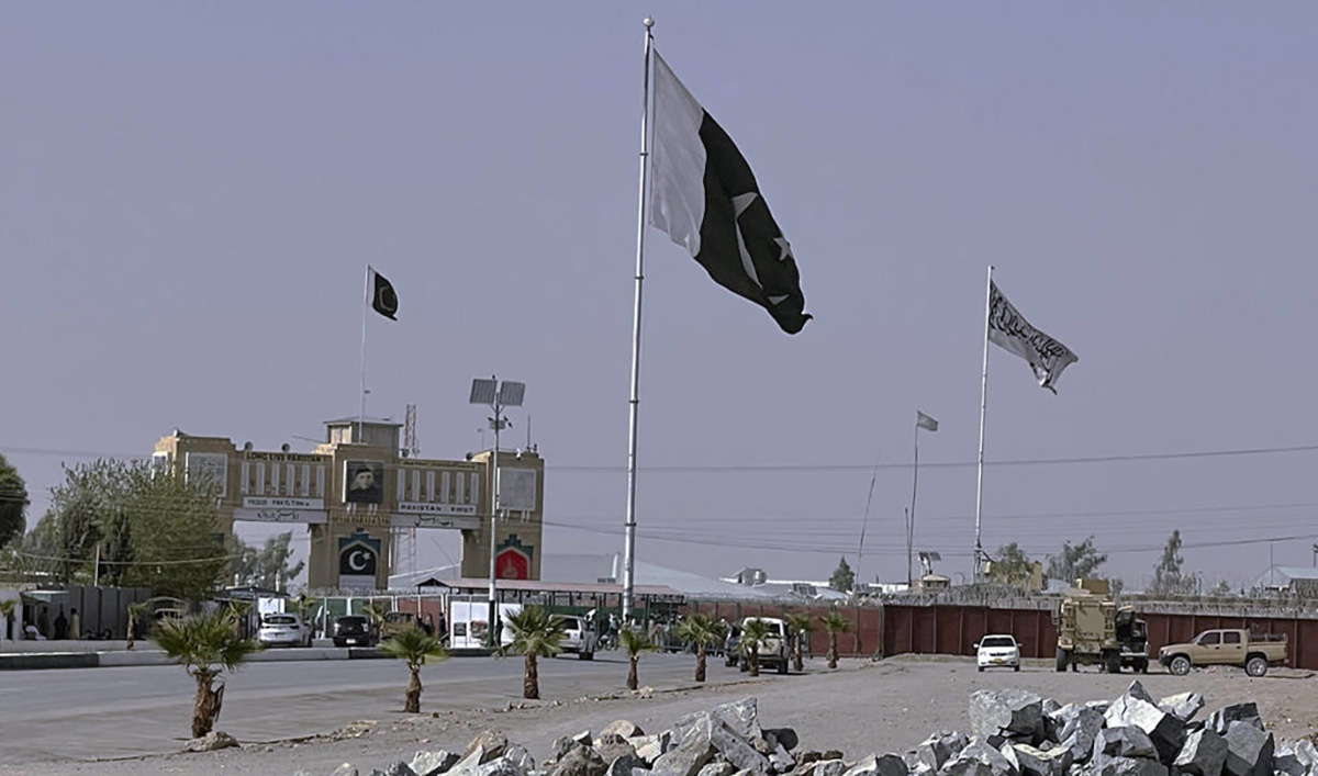 Pakistan and Taliban flags are seen on their respective sides near Friendship gate at a border crossing point in Chaman, Pakistan on August 27, 2021. (AP/File)