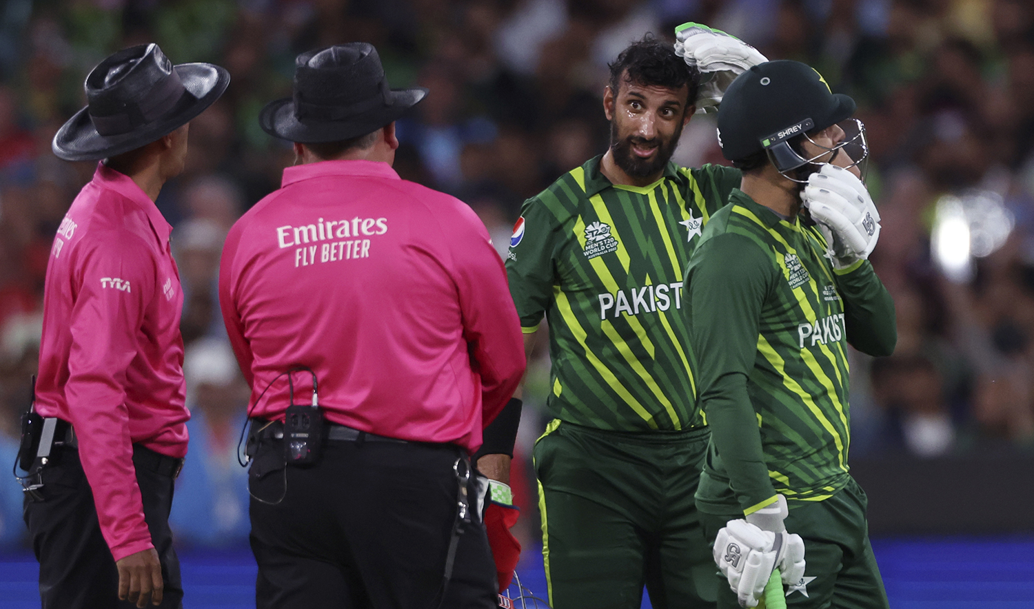 The umpires check on Pakistan's Shan Masood, second right, after he is hit in the head by a delivery from England during the final of the T20 World Cup Cricket tournament at the Melbourne Cricket Ground in Melbourne, Australia, on November 13, 2022. (AP)