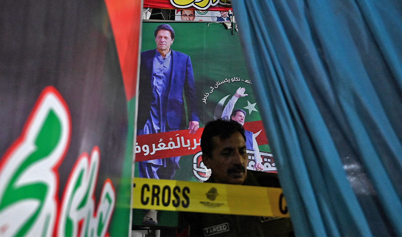 A police officer stands guard in front of container truck used by the former Pakistani prime minister Imran Khan during his political rallies, hours after a gun attack in Wazirabad, Pakistan, on November 3, 2022. (AFP)