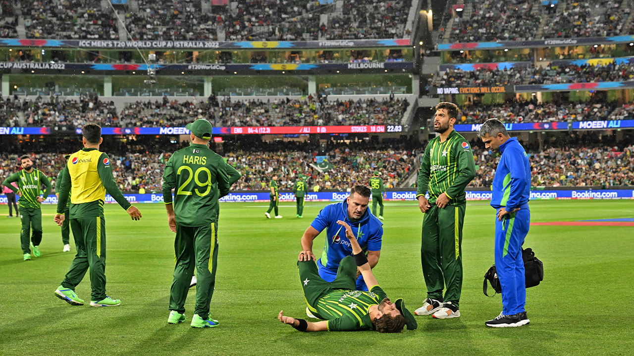 Pakistan's Shaheen Shah Afridi (C) lies on the ground as he receives treatment after injury during the ICC men's Twenty20 World Cup 2022 final cricket match England and Pakistan at The Melbourne Cricket Ground (MCG) in Melbourne, Australia, on November 13, 2022. (AFP)