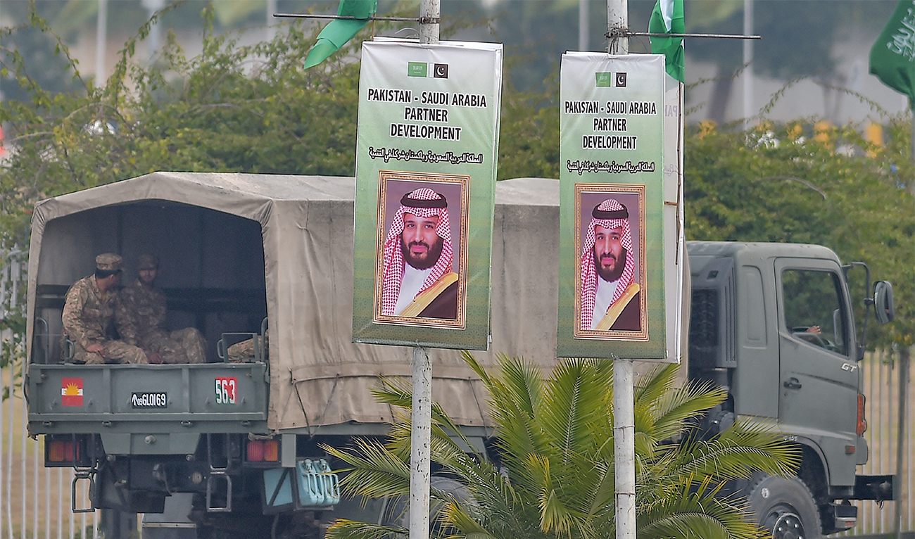 In this picture taken on February 17, 2019, Pakistani soldiers patrol on a street next to welcoming posters of Saudi Arabian Crown Prince Mohammed bin Salman in Islamabad, Pakistan. (AFP/File)