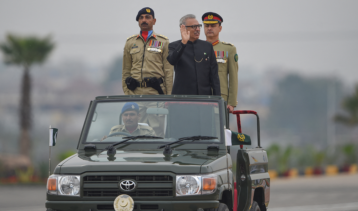 Pakistani President Arif Alvi, center, inspects the honor guard during the Pakistan Day parade in Islamabad on March 23, 2019. (AFP/File)