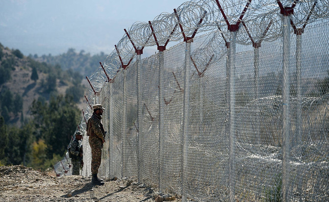 In this representational photo, Pakistani soldiers keep vigil next to fenced border fencing along with Afghan's Paktika province border in Angoor Adda in Pakistan's South Waziristan tribal agency on October 18, 2017. (AFP/File)